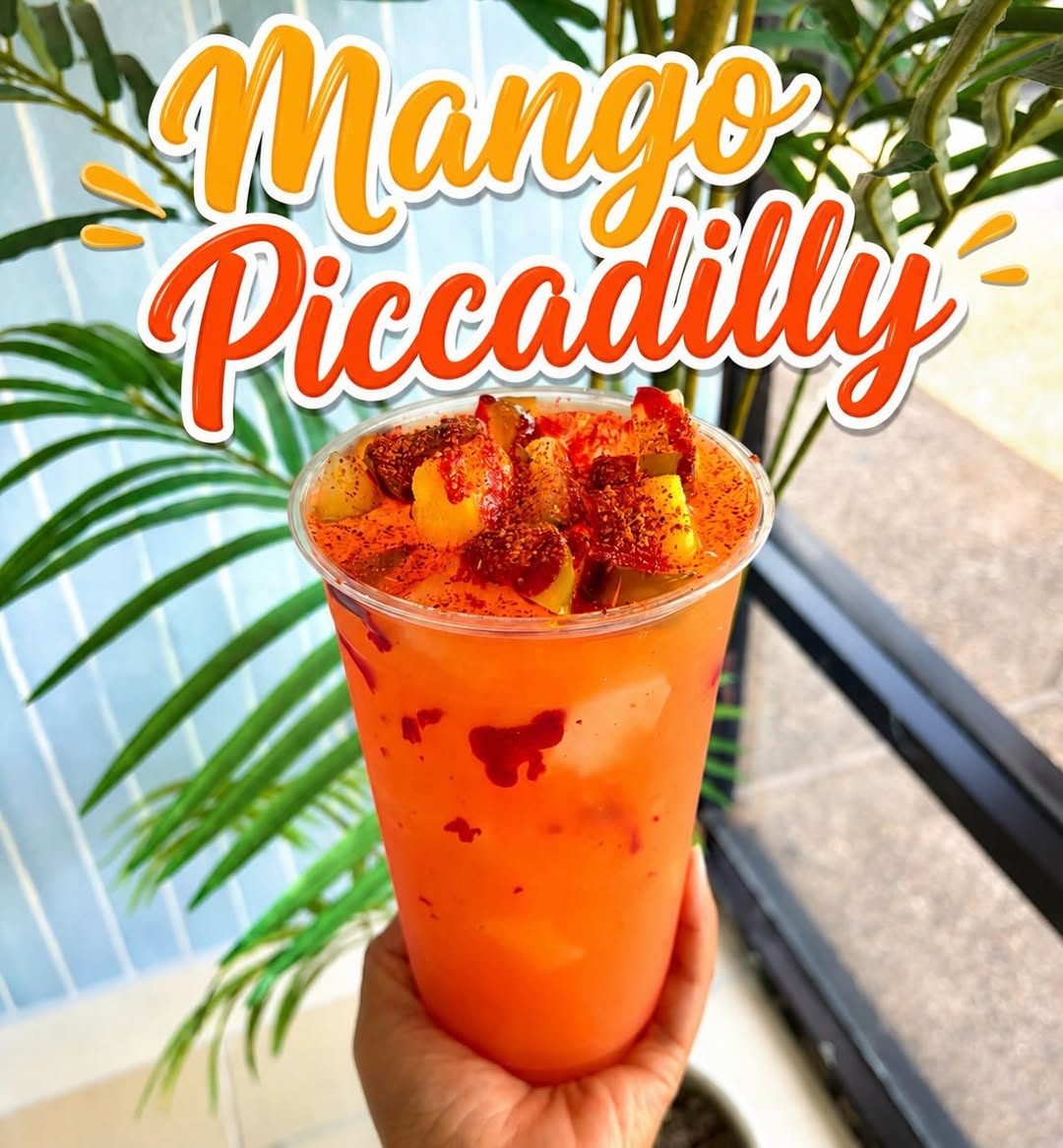 Mango Piccadilly loaded drink topped with fruit and tajín