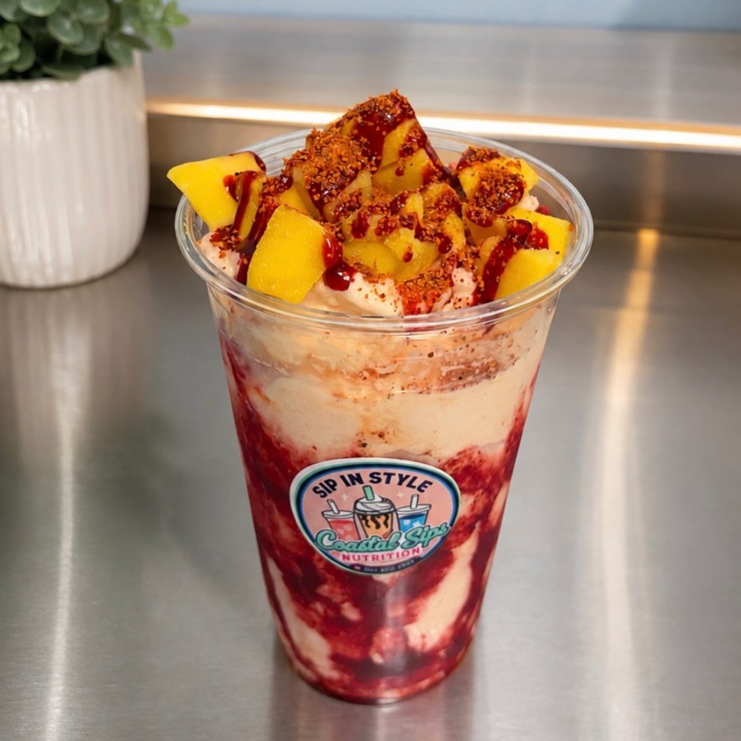 Mangonada dessert cup topped with tajín and chamoy