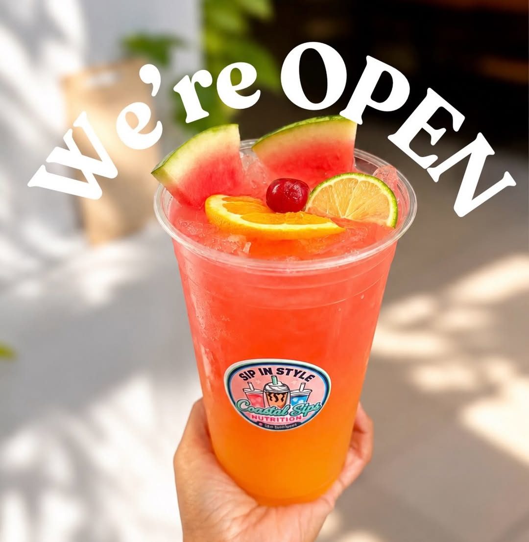 We're Open sign held over a Coastal Sips loaded drink
